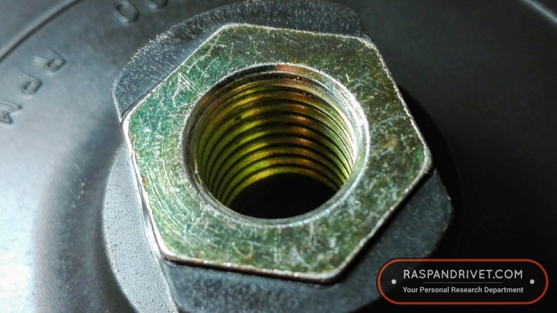 The angle grinder backing pad connects via 14mm thread.