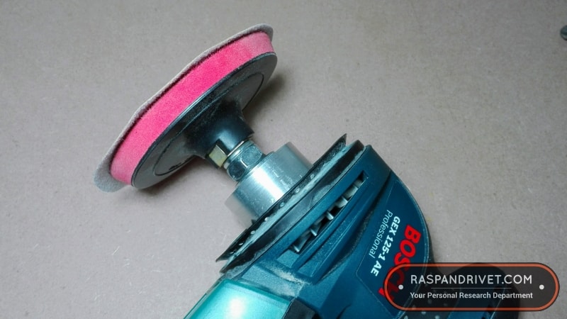The cheap angle grinder velcro backing plate screwed onto the adaptor.